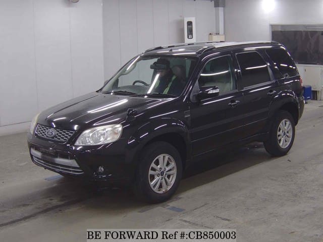 A grey JDM sports car speeding down a highway at night.