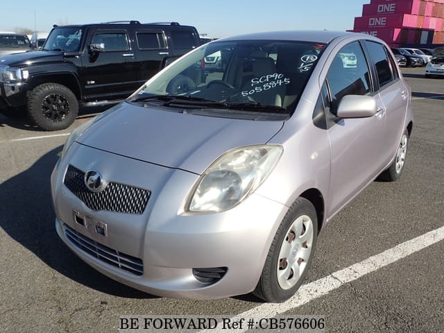 A grey JDM sports car speeding down a highway at night.