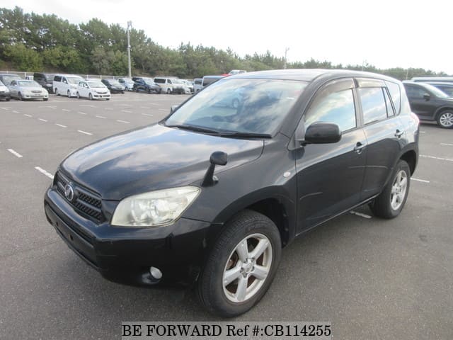 A grey JDM sports car speeding down a highway at night.