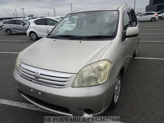 A grey JDM sports car speeding down a highway at night.