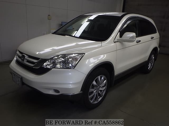 A grey JDM sports car speeding down a highway at night.