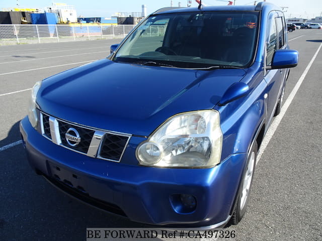 A grey JDM sports car speeding down a highway at night.