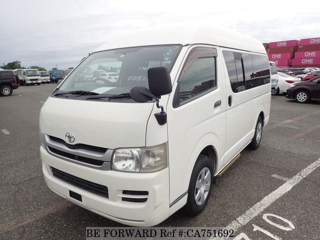 A grey JDM sports car speeding down a highway at night.