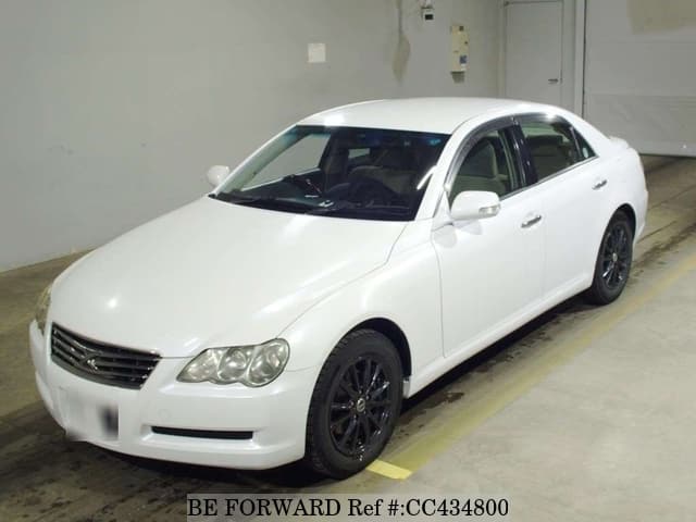 A grey JDM sports car speeding down a highway at night.