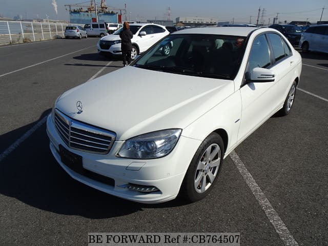 A grey JDM sports car speeding down a highway at night.