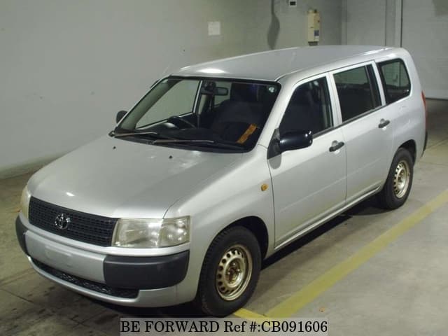 A grey JDM sports car speeding down a highway at night.