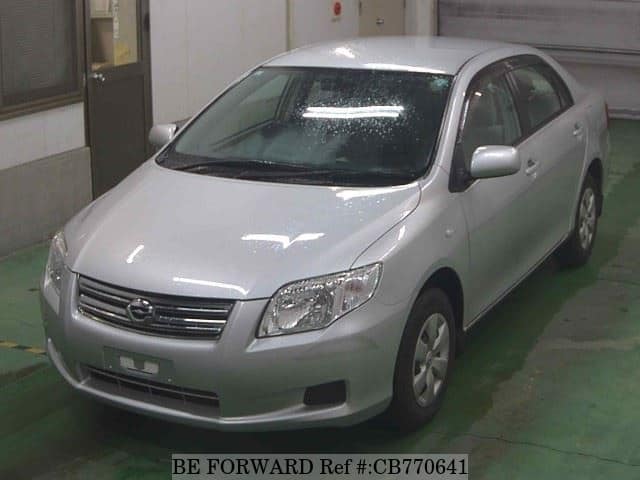 A grey JDM sports car speeding down a highway at night.