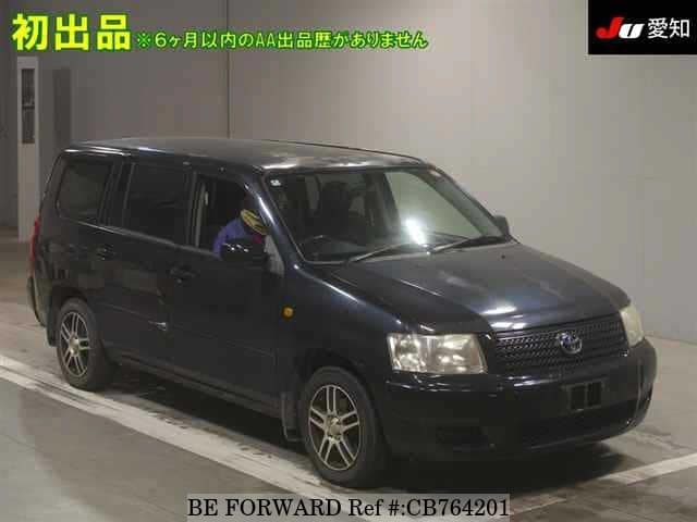 A grey JDM sports car speeding down a highway at night.