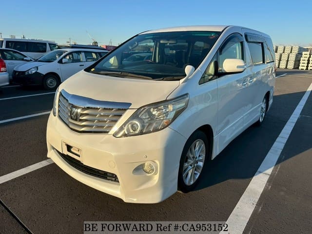 A grey JDM sports car speeding down a highway at night.
