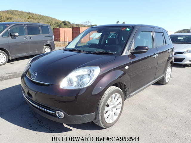 A grey JDM sports car speeding down a highway at night.