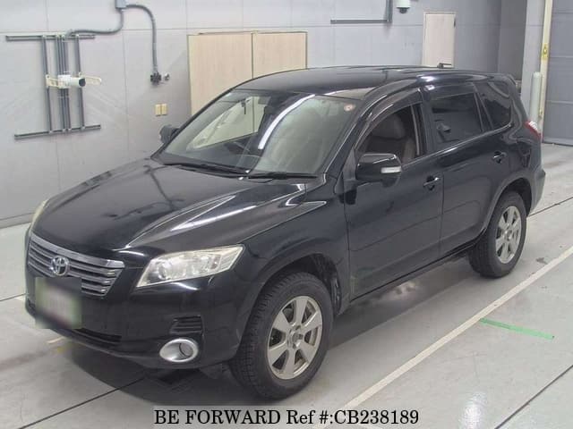 A grey JDM sports car speeding down a highway at night.