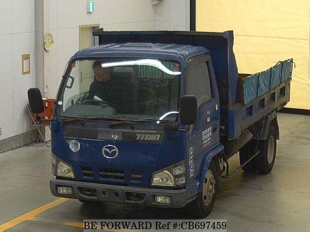 A grey JDM sports car speeding down a highway at night.