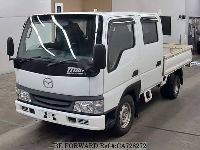 A grey JDM sports car speeding down a highway at night.