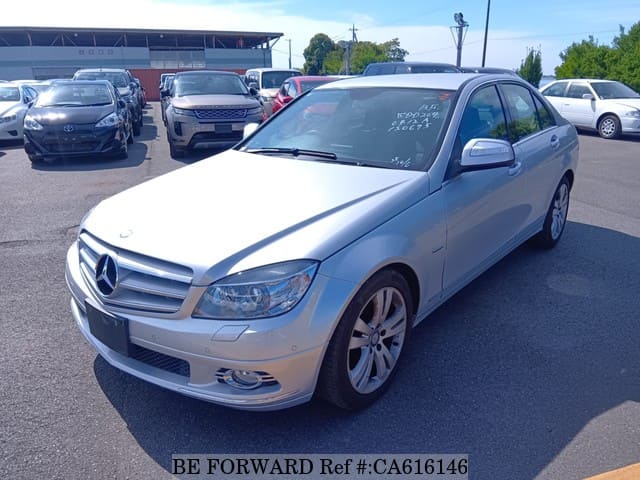 A grey JDM sports car speeding down a highway at night.