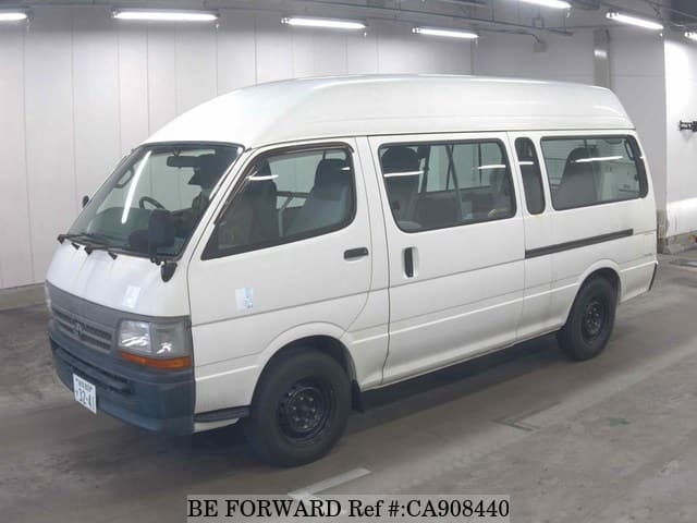 A grey JDM sports car speeding down a highway at night.