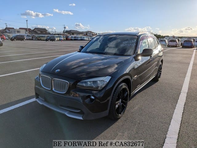 A grey JDM sports car speeding down a highway at night.