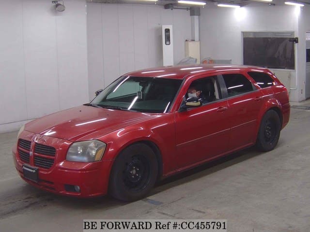A grey JDM sports car speeding down a highway at night.