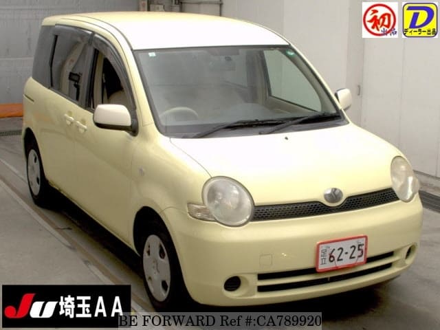 A grey JDM sports car speeding down a highway at night.