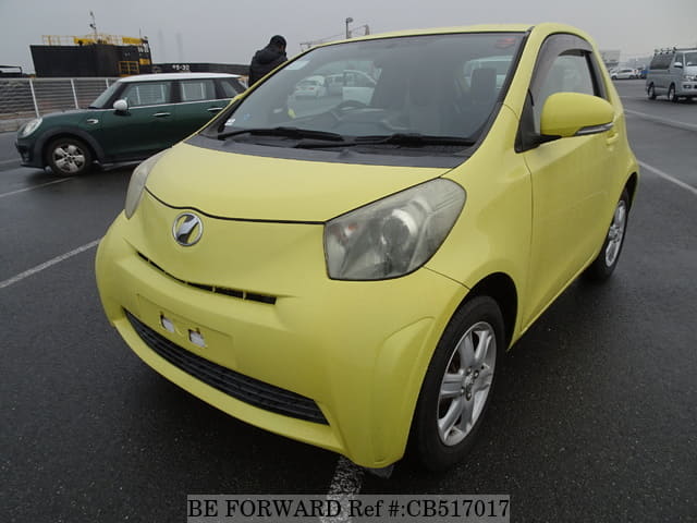 A grey JDM sports car speeding down a highway at night.