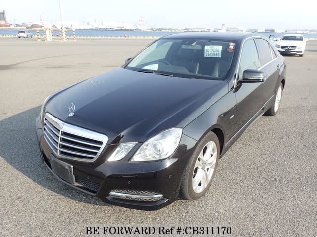 A grey JDM sports car speeding down a highway at night.