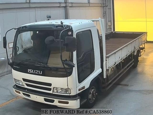 A grey JDM sports car speeding down a highway at night.