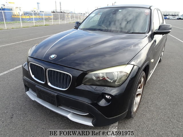 A grey JDM sports car speeding down a highway at night.