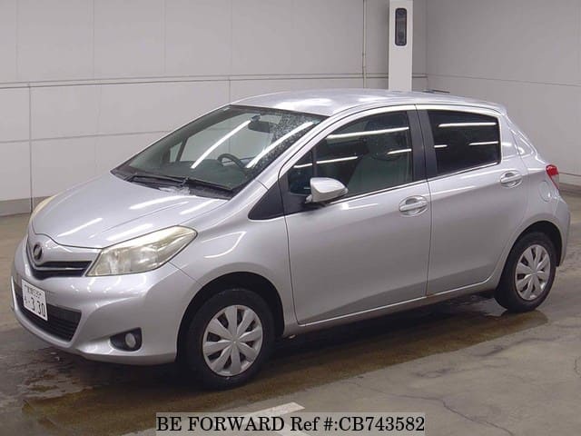 A grey JDM sports car speeding down a highway at night.