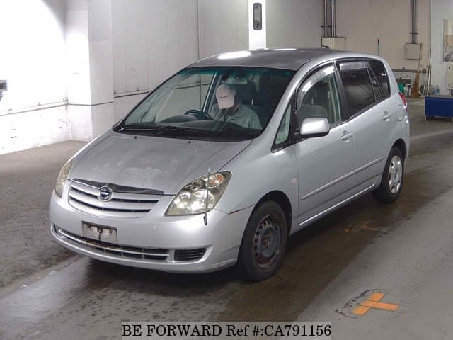 A grey JDM sports car speeding down a highway at night.