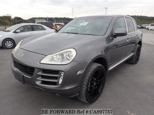 A grey JDM sports car speeding down a highway at night.