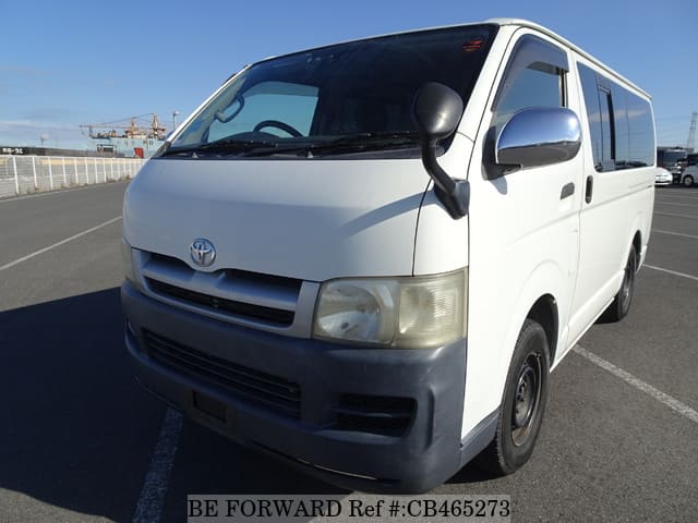 A grey JDM sports car speeding down a highway at night.