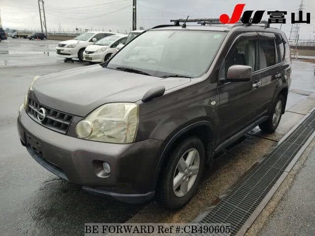 A grey JDM sports car speeding down a highway at night.