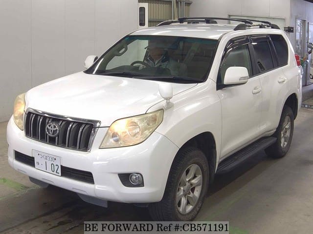 A grey JDM sports car speeding down a highway at night.