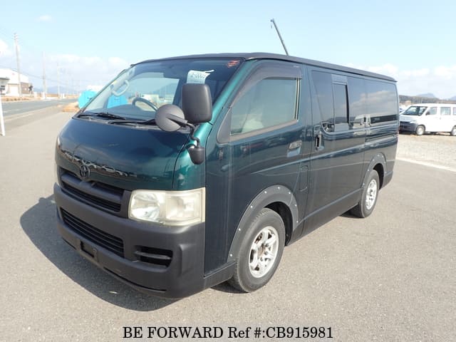 A grey sports car speeding down a highway at night.