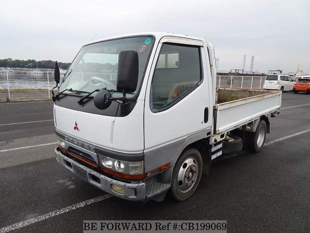 A grey JDM sports car speeding down a highway at night.