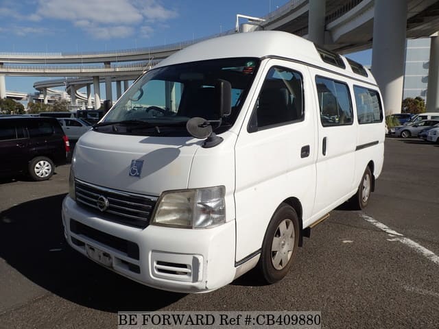 A grey JDM sports car speeding down a highway at night.