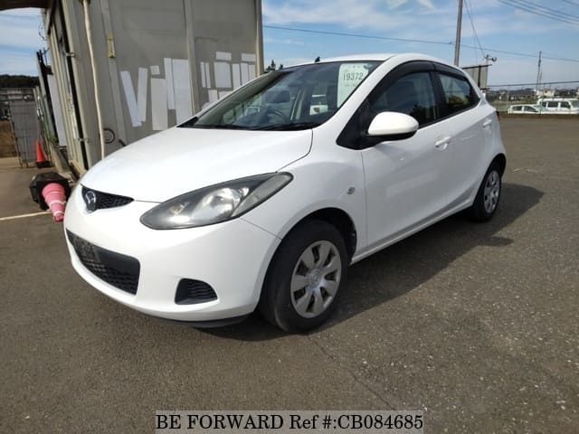 A grey JDM sports car speeding down a highway at night.