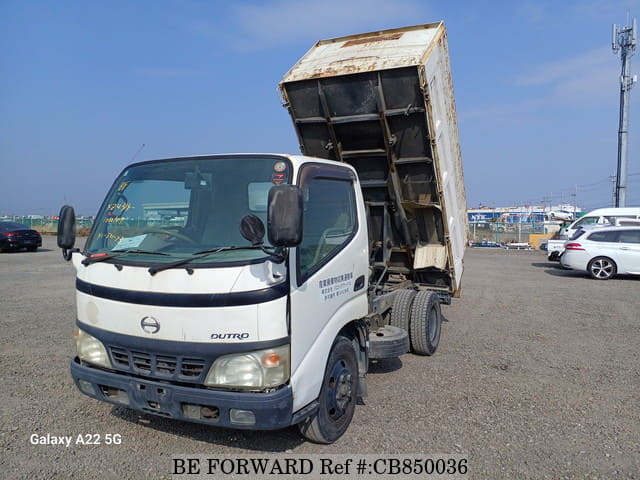 A grey JDM sports car speeding down a highway at night.