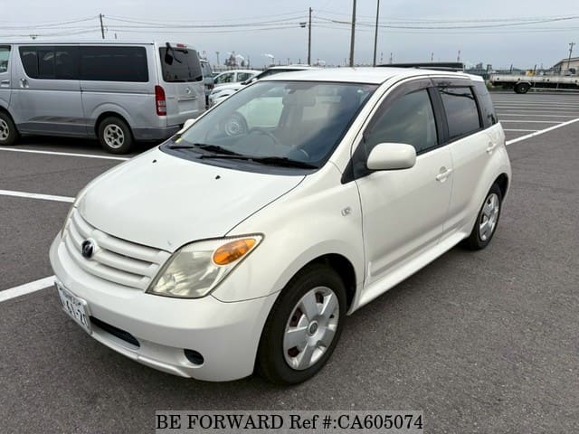 A grey JDM sports car speeding down a highway at night.
