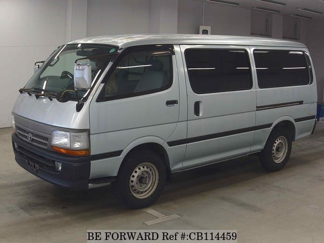 A grey JDM sports car speeding down a highway at night.