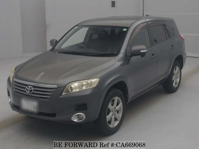 A grey JDM sports car speeding down a highway at night.