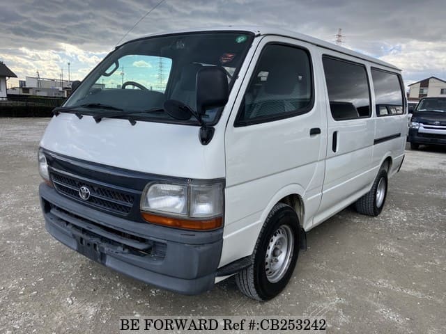 A grey JDM sports car speeding down a highway at night.