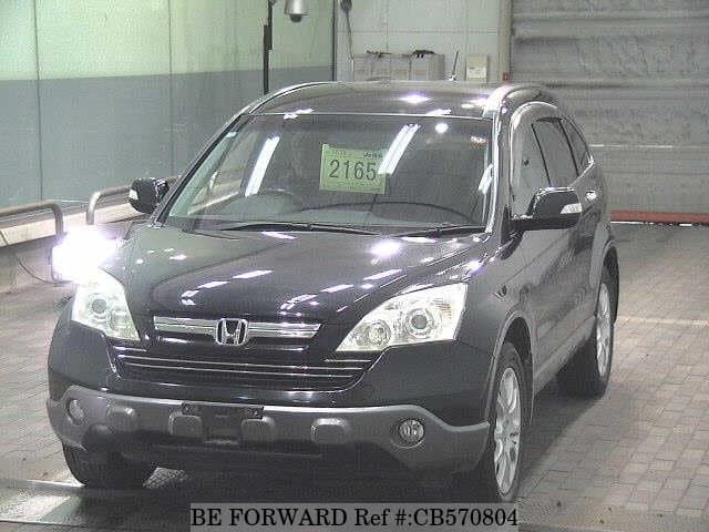 A grey JDM sports car speeding down a highway at night.
