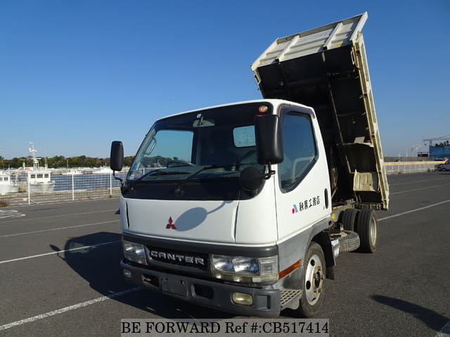 A grey JDM sports car speeding down a highway at night.
