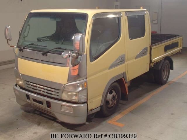 A grey JDM sports car speeding down a highway at night.