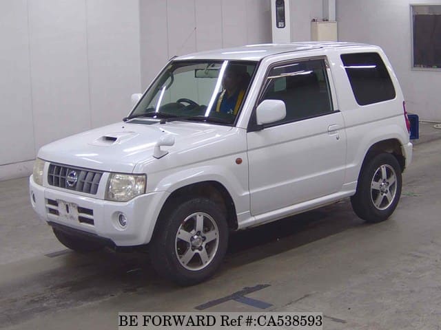 A grey JDM sports car speeding down a highway at night.