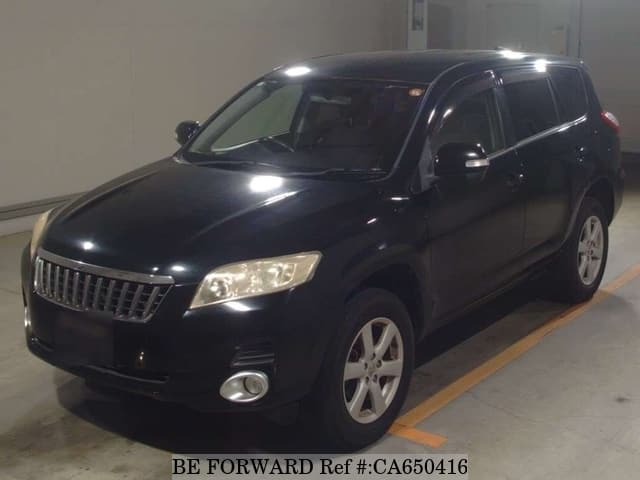 A grey JDM sports car speeding down a highway at night.