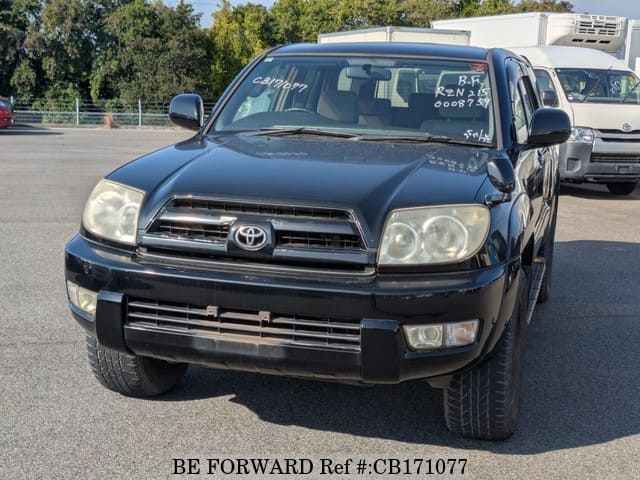 A grey JDM sports car speeding down a highway at night.
