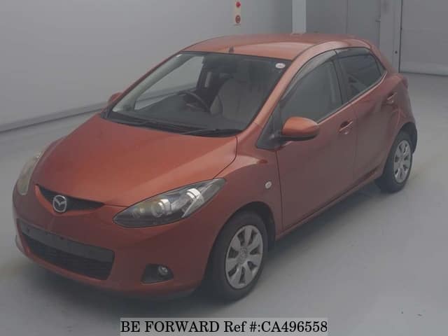 A grey JDM sports car speeding down a highway at night.