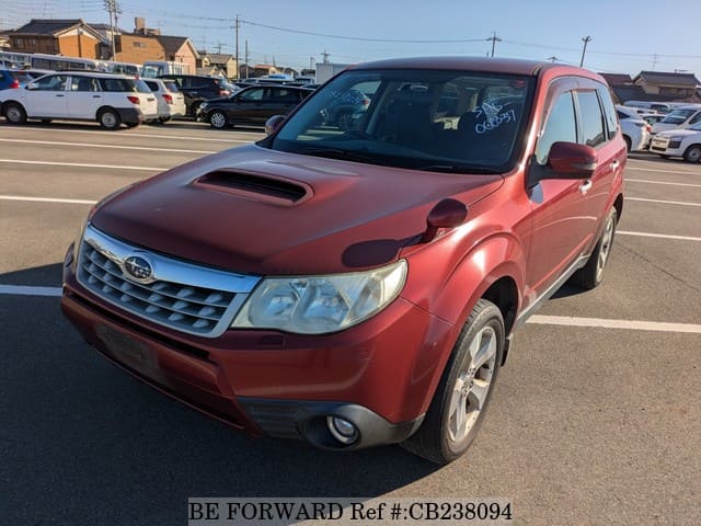A grey JDM sports car speeding down a highway at night.