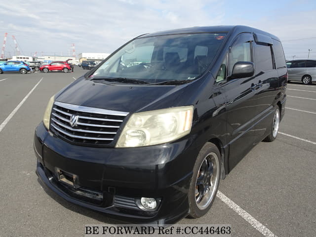 A grey JDM sports car speeding down a highway at night.